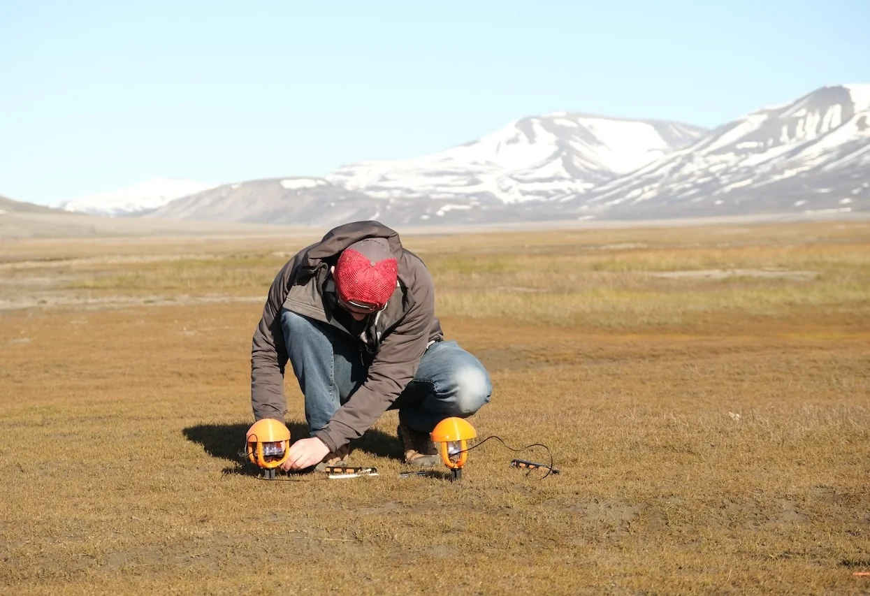 Patrick deploying acoustic sensors in the Arctic landscape of Svalbard